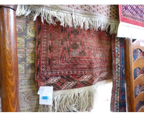A 20th Century small red Bokhara red rug, decorated with a central panel, 162x118cm