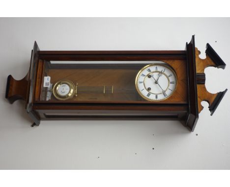 Late 19th century walnut and ebonised Vienna wall clock with broken arched pediment over a single glazed door, the brass and 