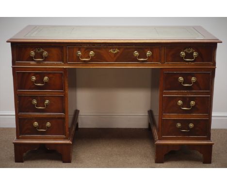 Reproduction mahogany twin pedestal desk, with green leather inset top and nine drawers, on shaped bracket supports, W123cm, 