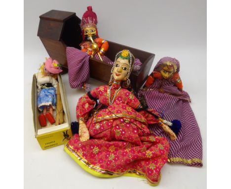 Three Indian painted wood and cloth marionette puppets, Pelham Standard puppet, boxed and a Victorian mahogany dolls cradle, 