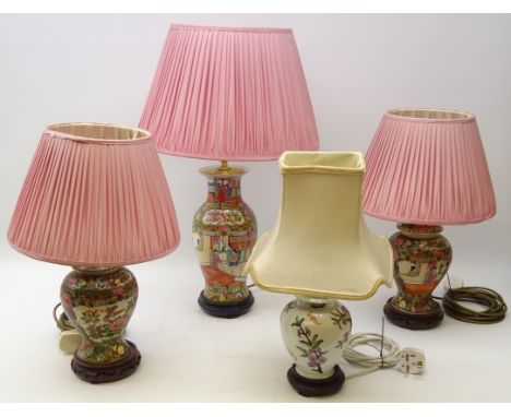 Pair 20th century Cantonese style Famille Rose baluster table lamps with pink pleated shades and hardwood stands and matching