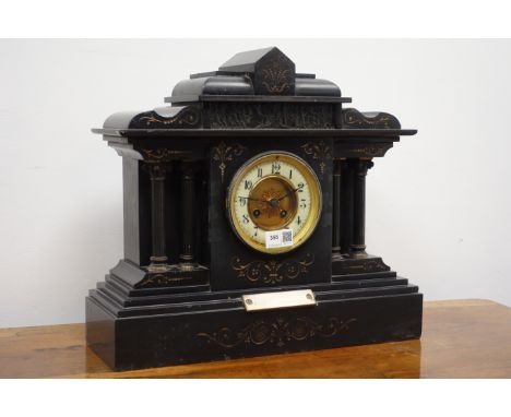 Victorian black slate architectural cased mantel clock with circular Arabic dial, twin train movement striking the half hours