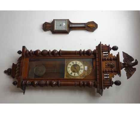 Late 19th century walnut cased Vienna wall clock with moulded eagle finial on stepped pediment over an arched top glazed door