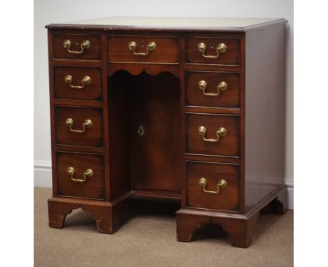 George l style mahogany kneehole desk, moulded top with leather inset writing surface, one long and eight short drawers, on b