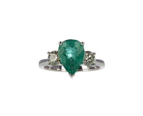 EMERALD AND DIAMOND THREE STONE RING set with a pear shaped emerald of approximately 2.17 carats, flanked by two round brilli