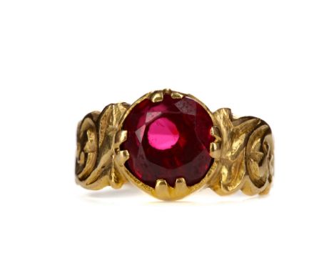 NINETEENTH CENTURY RED GEM SET RING, set with a faceted red gem to an ornate shank with scrollwork decoration on either shoul