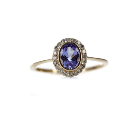 TANZANITE AND DIAMOND RING, set with an oval tanzanite within a halo of round brilliant cut diamonds totalling approximately 