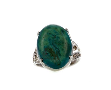 TURQUOISE RING, set with an oval cabochon turquoise 20mm long, with rose cut moissanites to either shoulder, partially marked