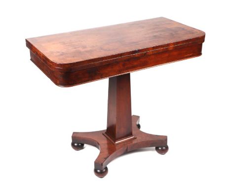 A 19th century mahogany card table, the crossbanded rectangular top on square tapering column and quatrefoil base, 92cms wide