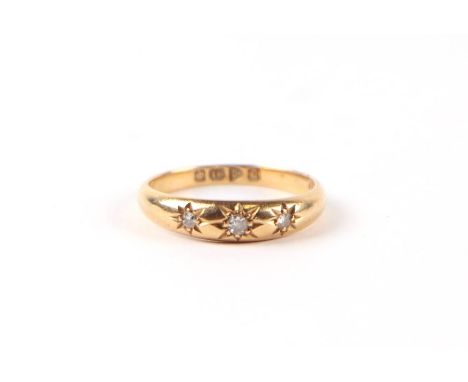 An 18ct gold threes stone diamond gypsy ring, approx UK size 'O', 3.2g.