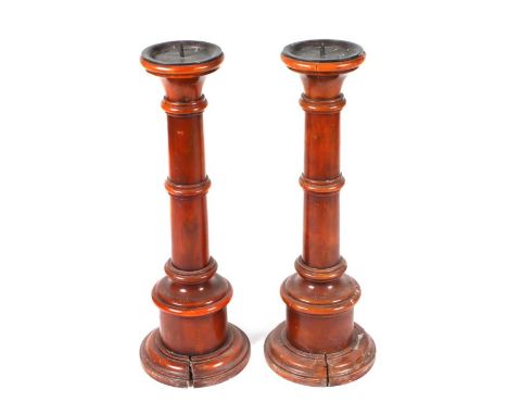 A pair of 19th century fruitwood floor standing pricket or candlesticks with tapering ring turned columns, on stepped bases, 