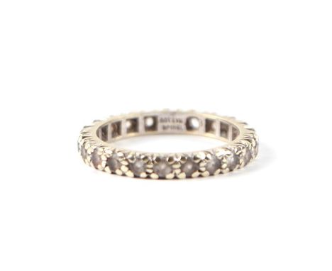 A 9ct white gold and spinel eternity ring, approx UK size 'M'.