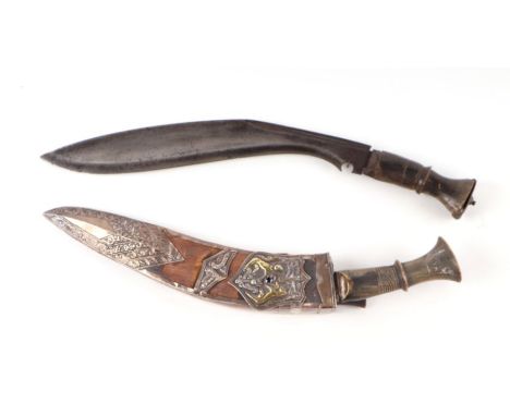 A horn handled kukri in a wooden scabbard with white metal overlay decoration depicting an armorial crest, overall 36cms long