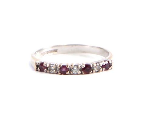 A 9ct  white gold dress ring set with red and white stones, approx UK size 'M', 1.3g.