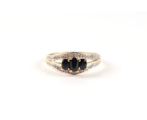 A 9ct gold three-stone sapphire ring, approx UK size 'P', 1.9g.