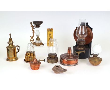 A group of small brass and copper oil and paraffin lamps to include a French Pigeon lamp and a Vapo-Resolene American vapour 