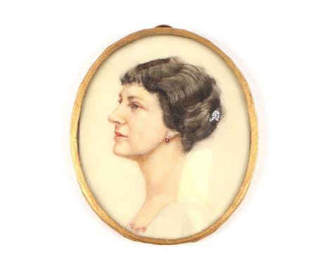 An early 20th century portrait miniature depicting a lady wearing ruby earrings, painted on ivorine, 8 by 9cms.