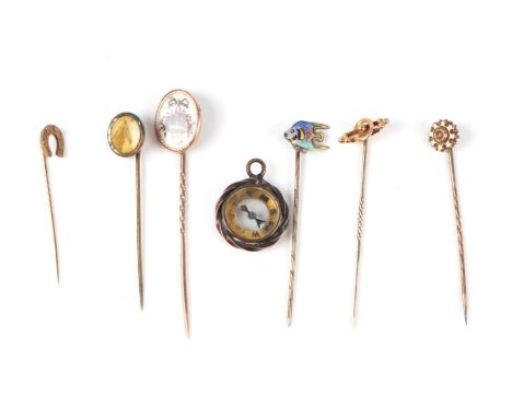 A 9ct gold horseshoe stick pin; together with five other stick pins and a fob compass (7).