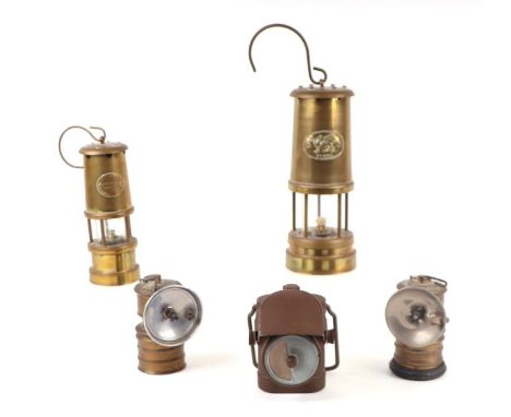Two brass miner's type lamps; together with a pair of Premier lamps and a military issue Lamps Electric No. 1 lamp (5).