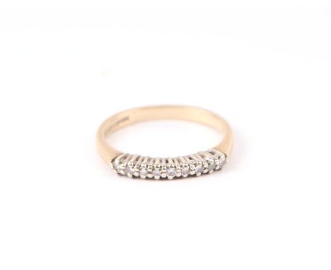 A 9ct gold ring set with nine small diamonds, approx UK size 'L', 1.9g.