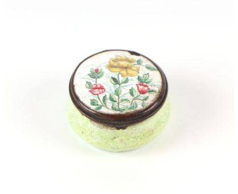 A Bilston enamel patch box, the cover with foliate decoration, the base with monochrome pale green enamel, 4cms diameter.Cond
