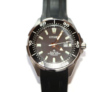 A Citizen Eco Drive 2000M titanium divers watch, the black having a date aperture, the titanium case fitted with a black rota