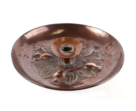 An Arts and Crafts Newlyn style copper candlestick decorated with bats, 22cms diameter.