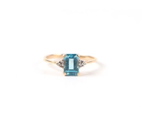 A 9ct gold dress ring set with a rectangular blue stone and diamond set shoulders, approx UK size 'L', 1.5g.