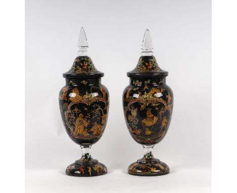 A large pair of glass urns and covers, reverse decorated with decoupage, on a slate grey ground, 44cms high; together with a 