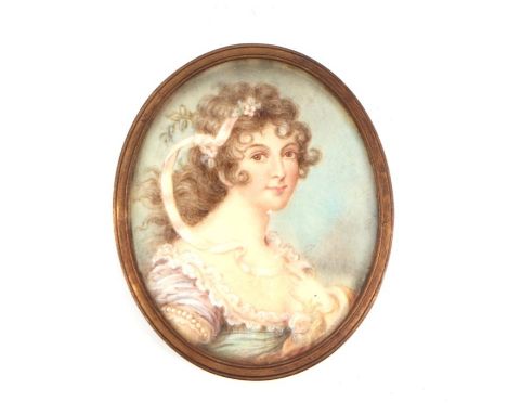 A 19th century portrait miniature on ivory depicting a young girl with a ribbon in her hair, framed &amp; glazed, 5.5 by 7cms