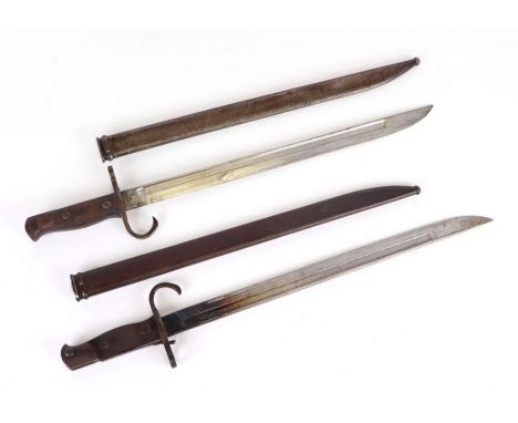 A Japanese Arisaka Naval model bayonet with steel scabbard, 43cms long; together with another similar (lacking wooden grip) (