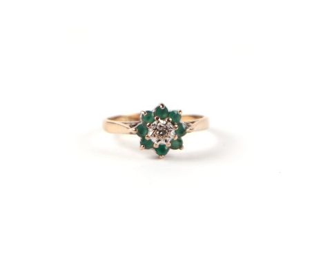 A 9ct gold diamond and emerald flower head cluster ring, approx UK size 'K', 1.8g.