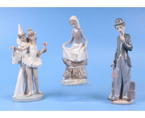A Lladro Charlie Chaplin figure, model no. 5233, 28cms high; together with two other figures, Girl and Rabbit, model no. 4826