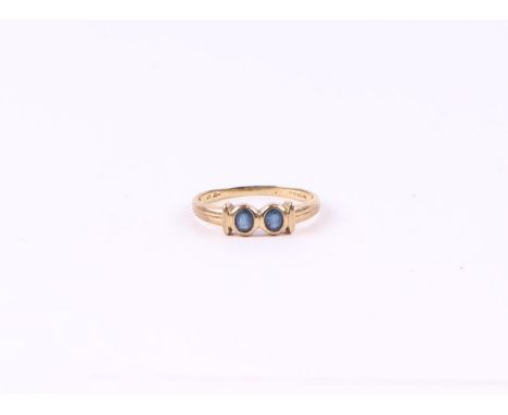 A 9ct gold ring set with two pale sapphires, approx UK size 'O', 1.6g.