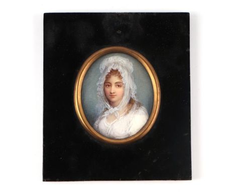 A portrait miniature on ivory depicting a young girl wearing a bonnet, framed &amp; glazed, the miniature 6 by 7cms.(Self-dec