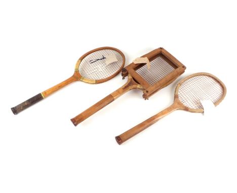 Three early 20th century wooden tennis racquets including the Slazenger Victory (1914) with press, the club with combed handl