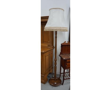 OAK STANDARD LAMP
raised on a circular base with a turned and shaped column and a shaped cream tasselled shade, 191cm overall