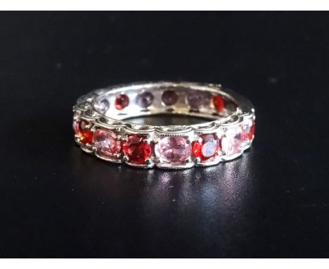 UNUSUAL PINK AND ORANGE GEM SET 3/4 ETERNITY RING
with alternating round cut orange gemstones and oval cut pink gemstones, in