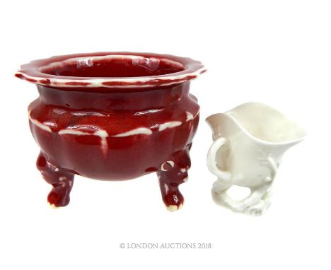 A sang de boeuf ceramic censer together with a small blanc de chine single handled cup. (2)