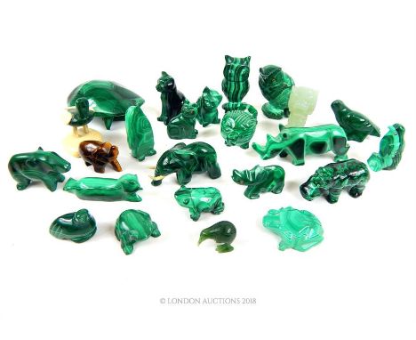 A large collection of twenty-one, carved malachite animal figurines, a jade dragon and kiwi bird with a tiger's eye elephant.