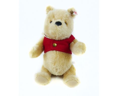 A Steiff soft toy Winnie the Pooh with articulated limbs and original box.