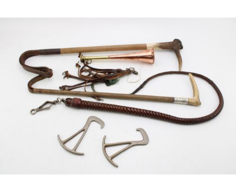 A collection of Hunting accessories to include  a leather game hanger, two stag antler riding crops, a pair of boot pulls, a 