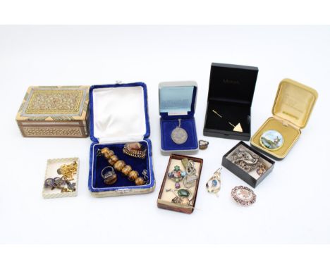 A mixed collection of costume jewellery and silver items to include vintage tigers eye ring, bracelet and smokey quartz brooc