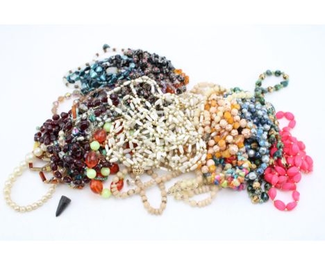 A group of early mid-century and later bead necklaces, including two strings of faceted amber coloured beads, various strings
