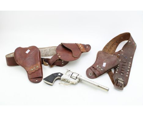 Two vintage toy gun holsters together with a BCM Frontier cap gun. (2)