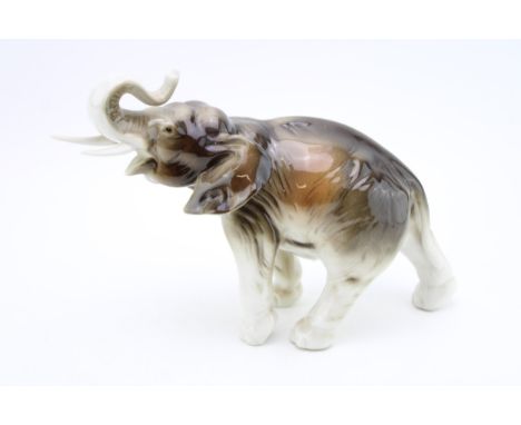 Royal Dux figure of an elephant with outstretched trunk, 32cm long.  In good condition with no obvious damage or restoration.