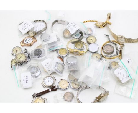 A large group of vintage wristwatches, early 20th century and later, many without straps.