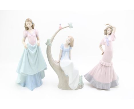 Three large Nao figurines to include a girl sat on a tree with two others (3), tallest 34cm tall.  In good condition with no 
