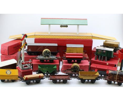 A collection of vintage Hornby O gauge (32mm) model railway items to include trucks, wagons and accessories. Of note boxed Ma