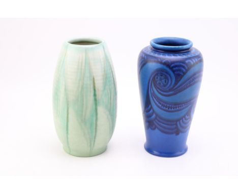 Two Royal Lancastrian vases, one with swirling design on blue background, the other mottled ribbed vase, 22.5cm tall.  In goo